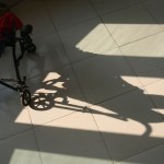A boy basks in the sunlight from a window at an orphanage for disabled children in China