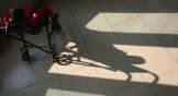 A boy basks in the sunlight from a window at an orphanage for disabled children in China