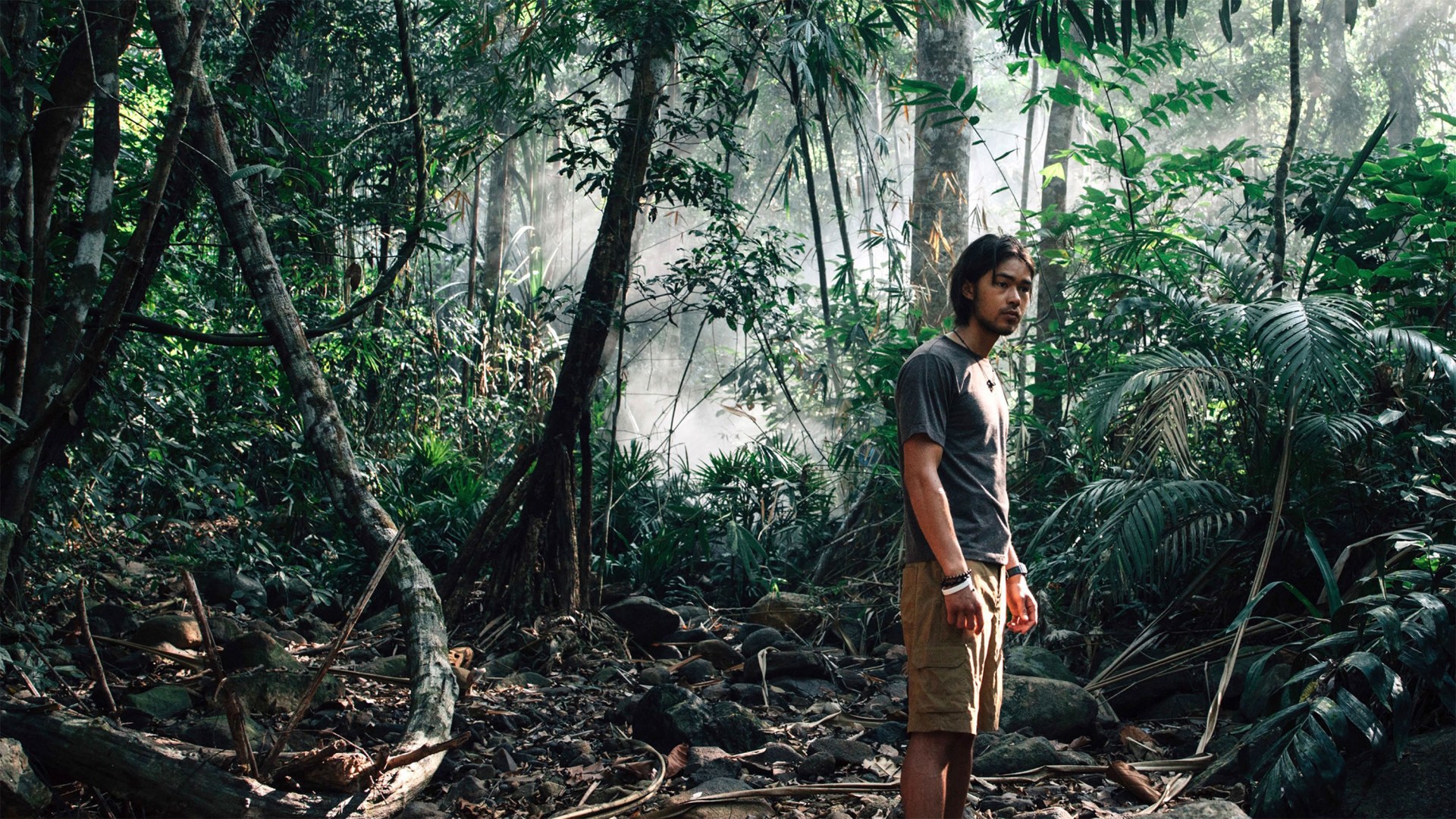 A film still showing the main character in the jungle.