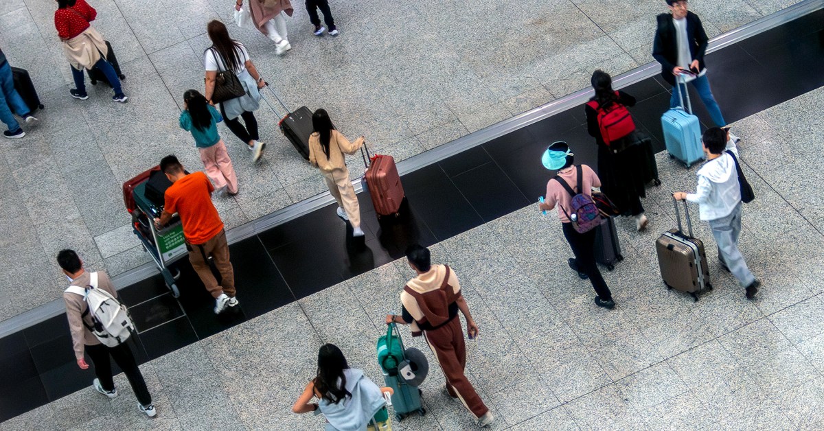 Flight passengers walking in the Hong Kong International Airport.