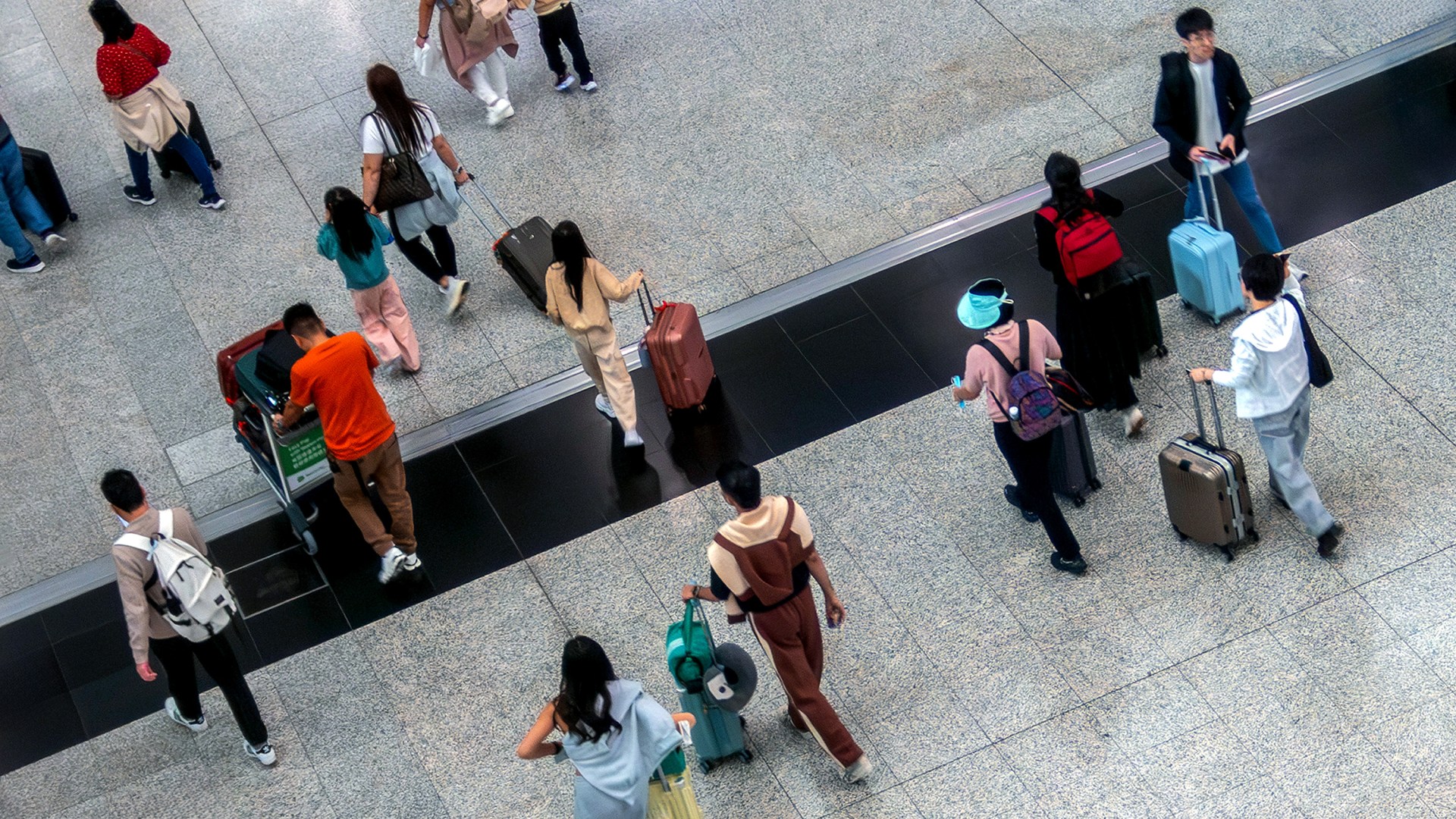 Flight passengers walking in the Hong Kong International Airport.