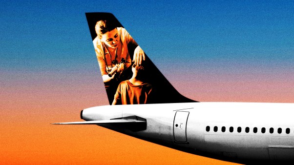 A photo of a woman helping a child on the tail of an airplane