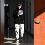 A student walking the halls of a school in China.